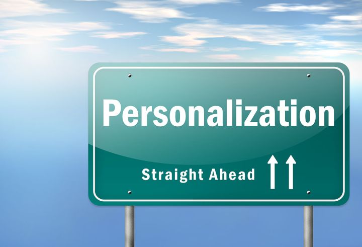 "Green road sign with the word 'Personalization' and the phrase 'Straight Ahead' accompanied by two upward-pointing arrows, set against a blue sky with clouds.
